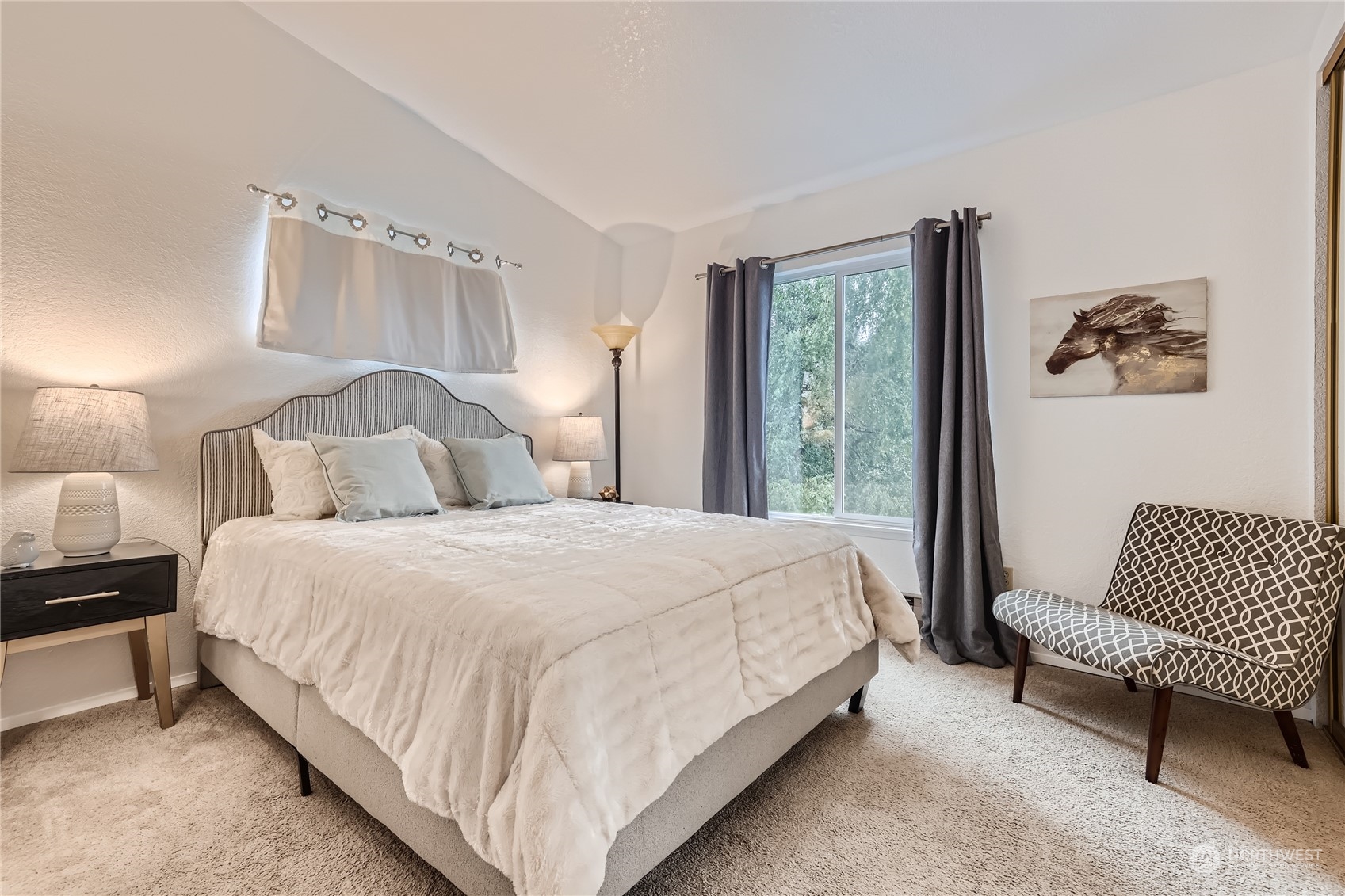 10830 East Riverside Drive, Unit B301 Bothell, WA 98011 - Photo 7 of 11 a bedroom with a bed and a couch