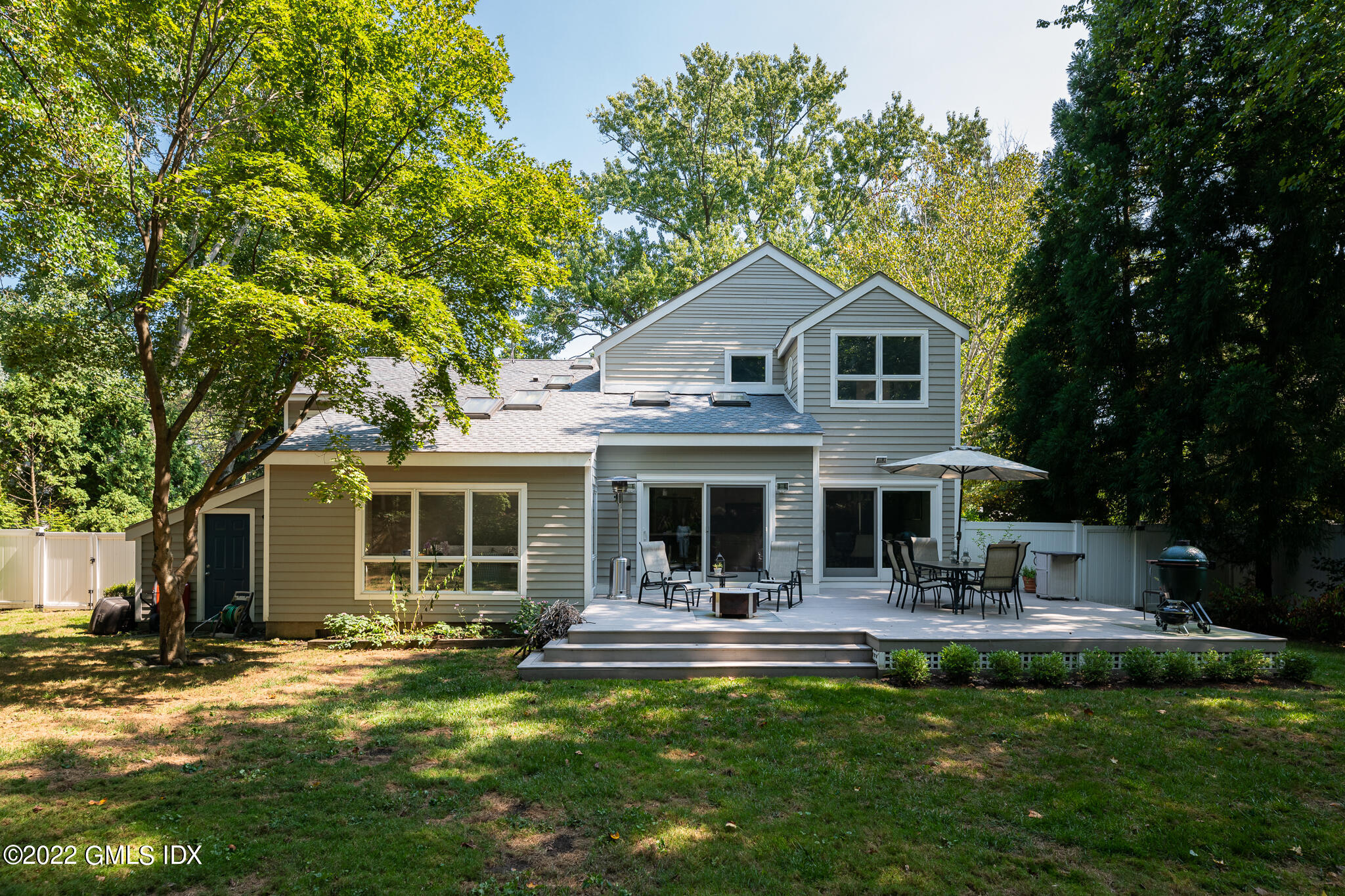 8 Verona Drive Riverside, CT 06878 - Photo 5 of 26 a front view of a house with swimming pool and porch with furniture