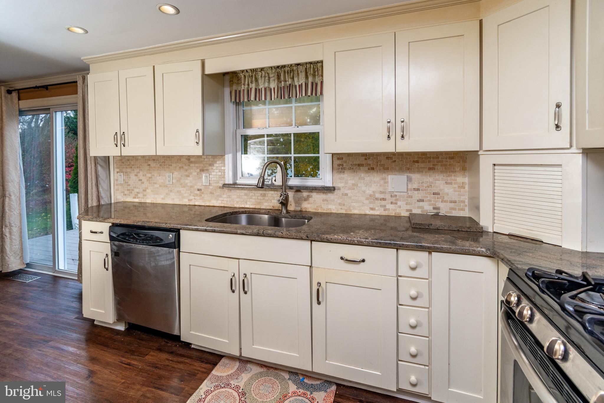 7 Pinehurst Court Hamilton, NJ 08690 - Photo 21 of 52 a kitchen with granite countertop white cabinets and a stove