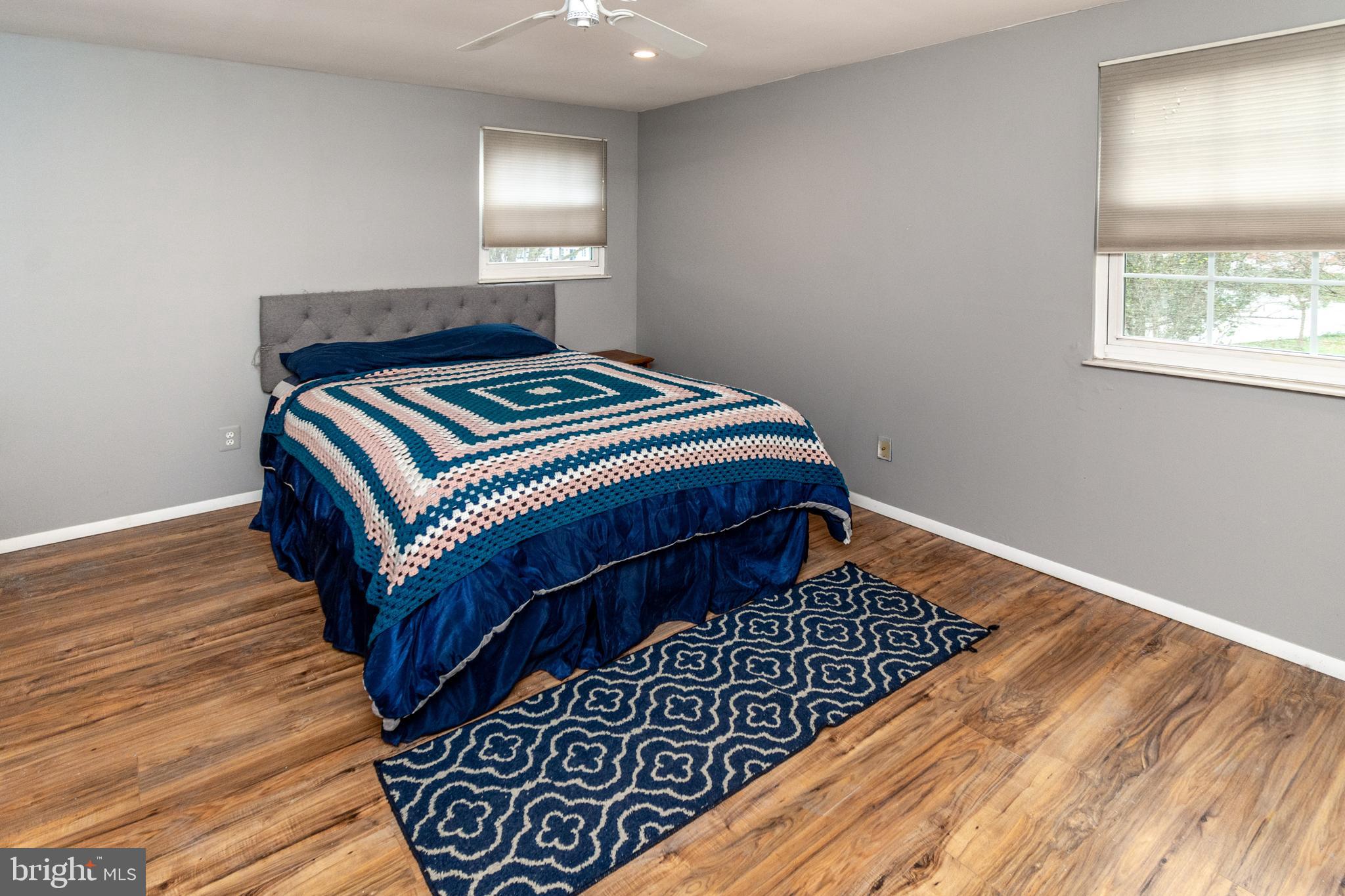 7 Pinehurst Court Hamilton, NJ 08690 - Photo 35 of 52 a bedroom with a bed rug and wooden floor