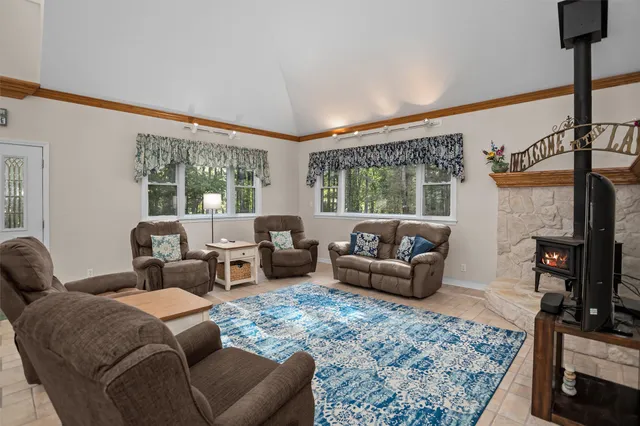 a living room with furniture and a floor to ceiling window