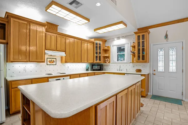 a kitchen with a sink a counter top space and cabinets