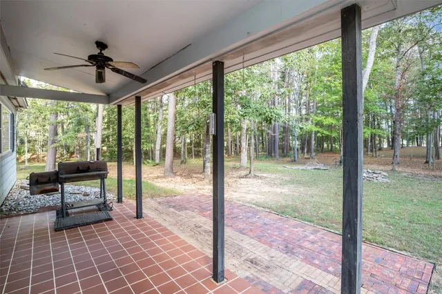 a front view of a house with a tree
