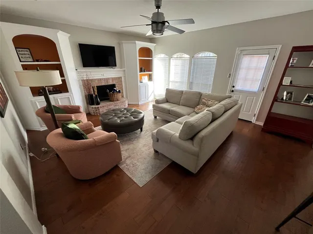 a living room with furniture fireplace and flat screen tv