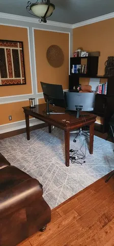 a living room with couch piano table and a lamp