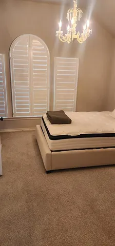 a bathroom with a bathtub and a chandelier