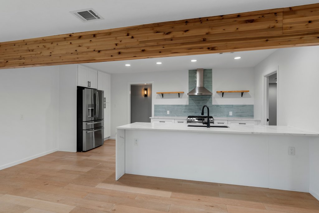 3404 Touchstone Street Austin, TX 78723 - Photo 12 of 32 Kitchen with open shelves, light stone counters, stainless steel appliances, white cabinetry, and recessed lighting