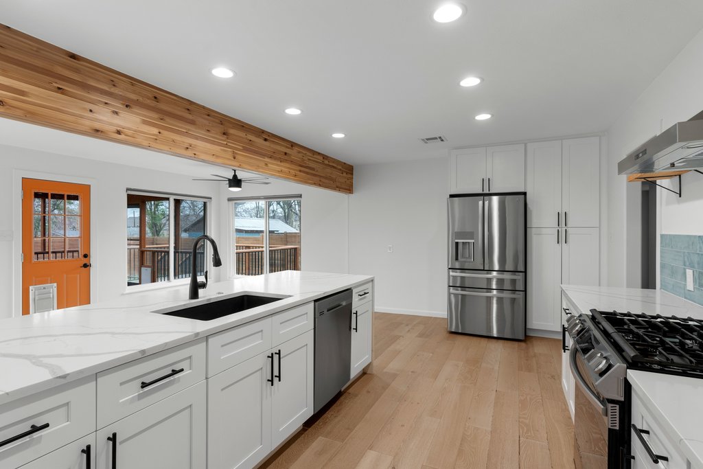 3404 Touchstone Street Austin, TX 78723 - Photo 14 of 32 Kitchen featuring recessed lighting, stainless steel appliances, white cabinetry, light wood-style floors, and light stone counters