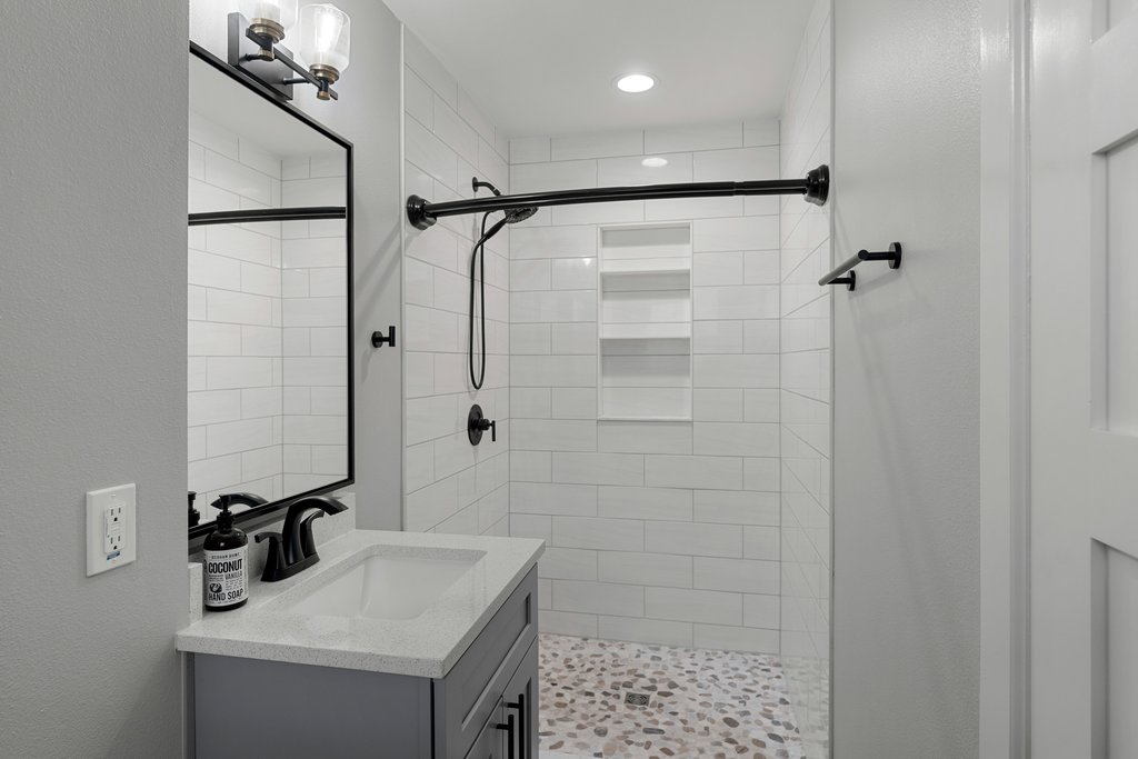 3404 Touchstone Street Austin, TX 78723 - Photo 19 of 32 Full bath with vanity, a shower stall, a textured wall, and recessed lighting