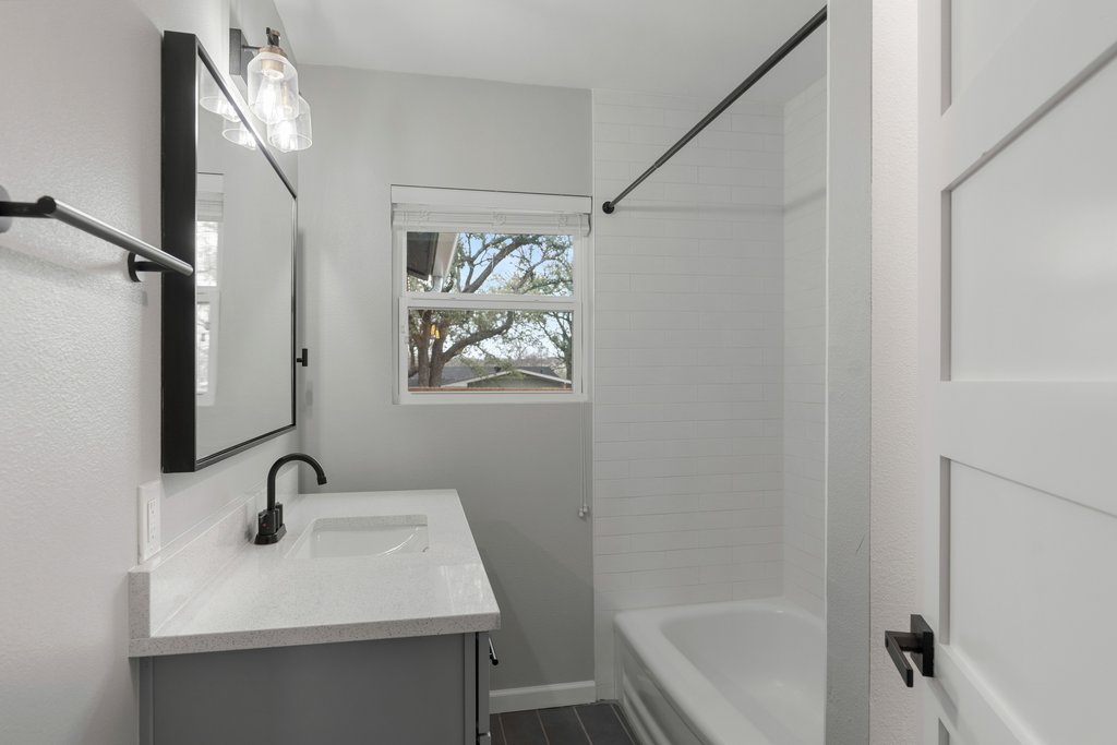 3404 Touchstone Street Austin, TX 78723 - Photo 20 of 32 Full bathroom featuring vanity and shower combination