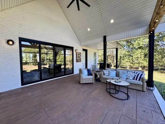 a large bed sitting in a bedroom next to a lamp
