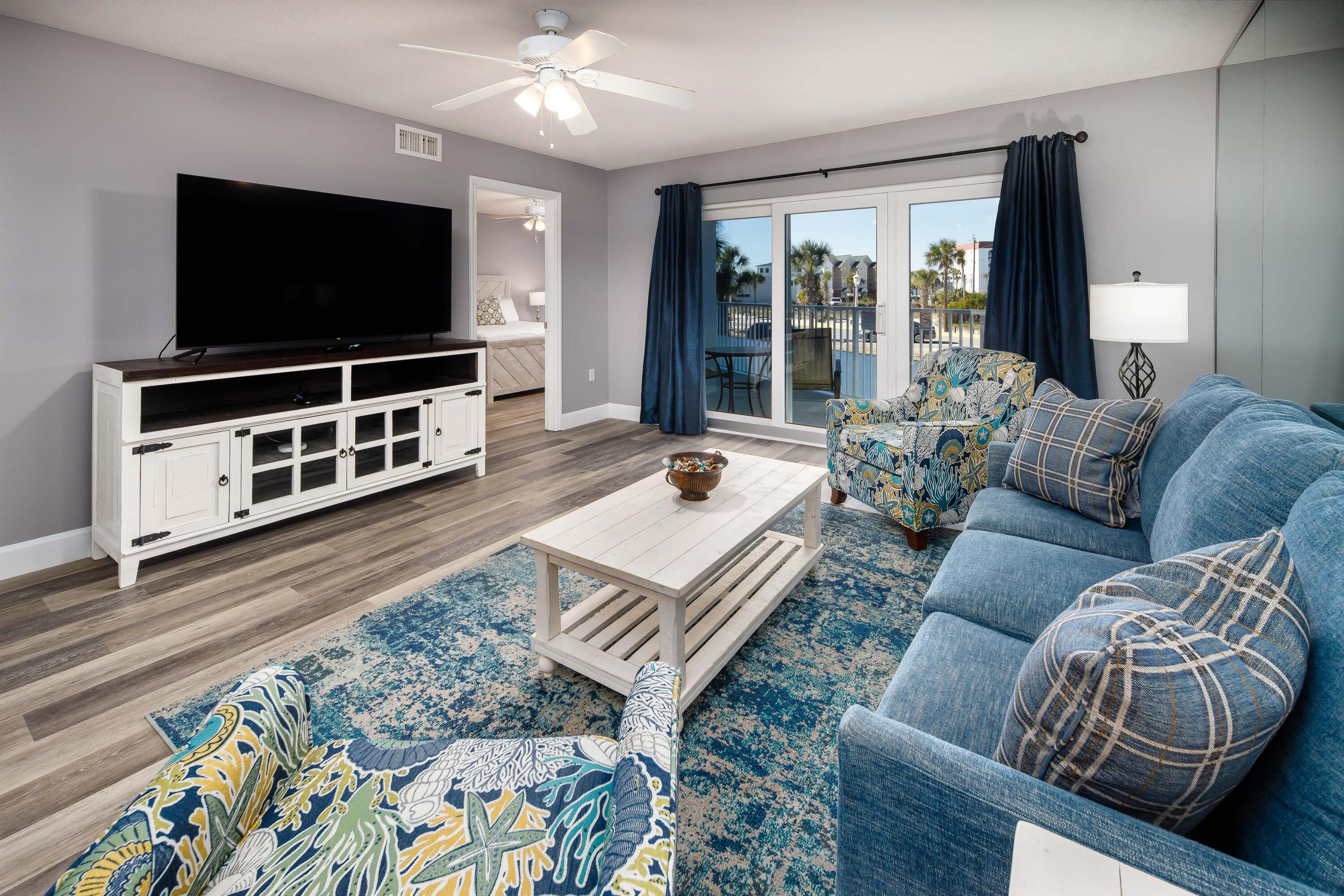 895 Santa Rosa Boulevard, Unit 208 Fort Walton Beach, FL 32548 - Photo 2 of 21 a living room with furniture and a flat screen tv