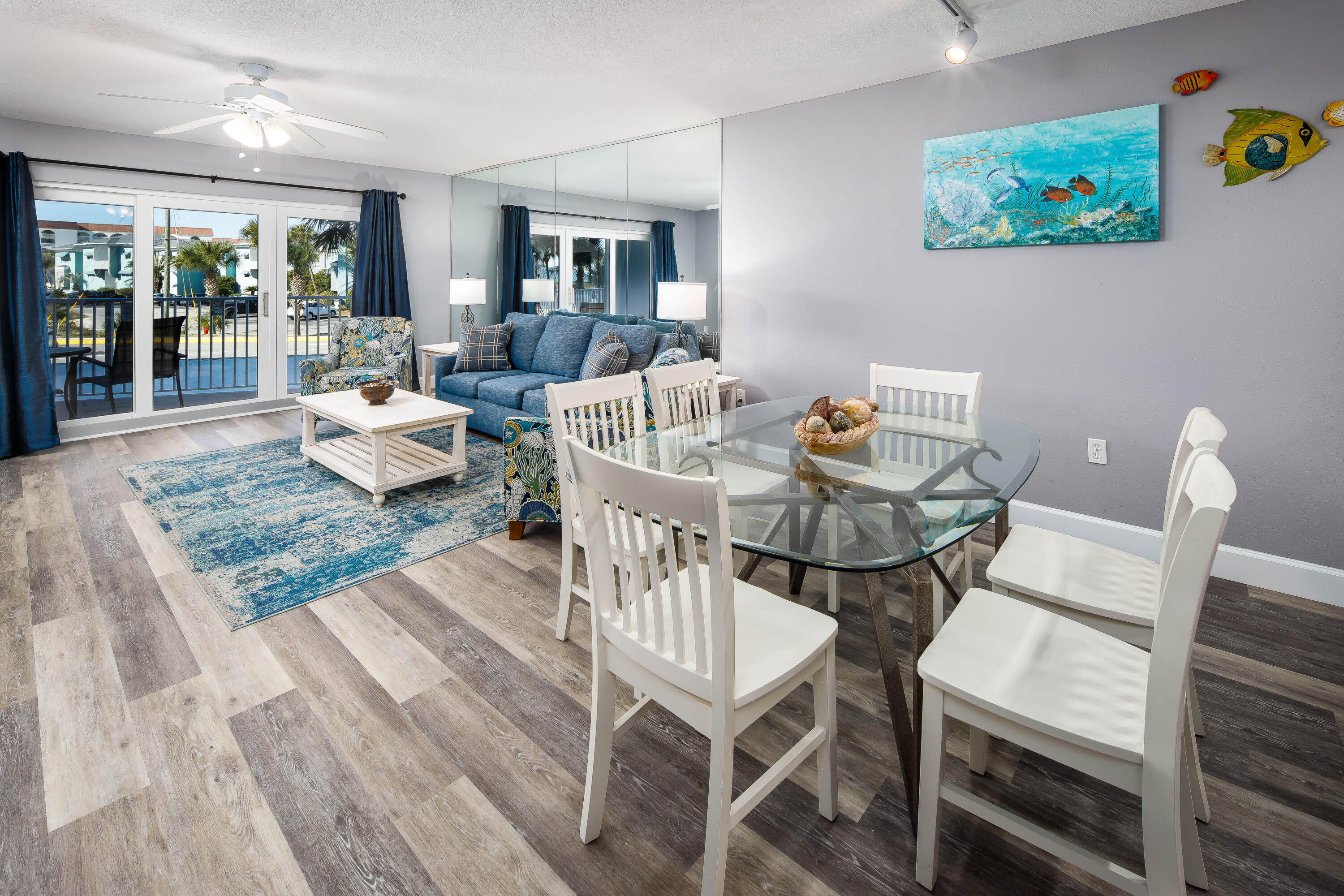 895 Santa Rosa Boulevard, Unit 208 Fort Walton Beach, FL 32548 - Photo 4 of 21 a view of a dining room with furniture a rug and wooden floor