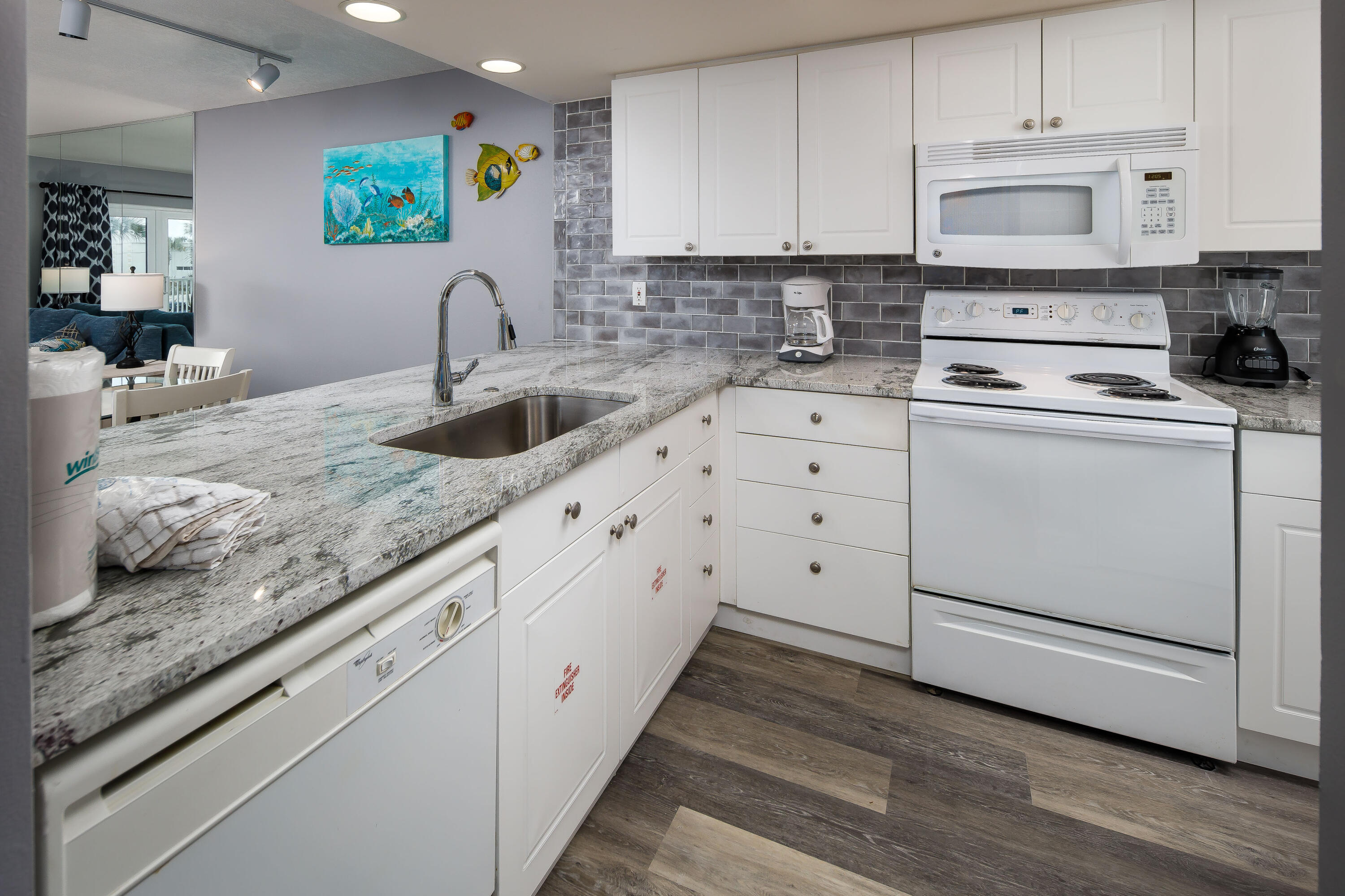 895 Santa Rosa Boulevard, Unit 208 Fort Walton Beach, FL 32548 - Photo 7 of 21 a kitchen with granite countertop a sink a stove and cabinets