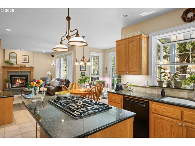 a kitchen with a stove a sink a dining table and chairs