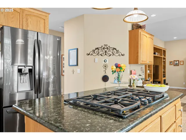 a kitchen with kitchen island a stove and a refrigerator