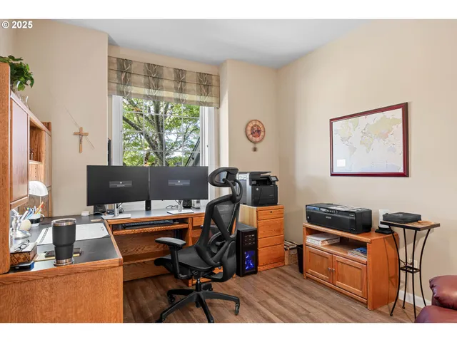 a work room with furniture and a large window