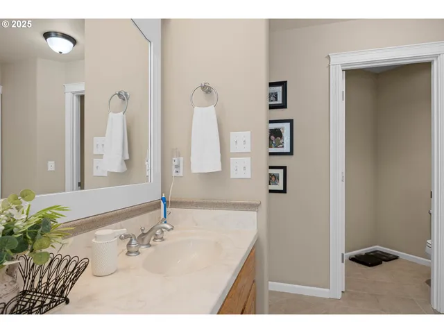 a bathroom with a sink vanity and a mirror