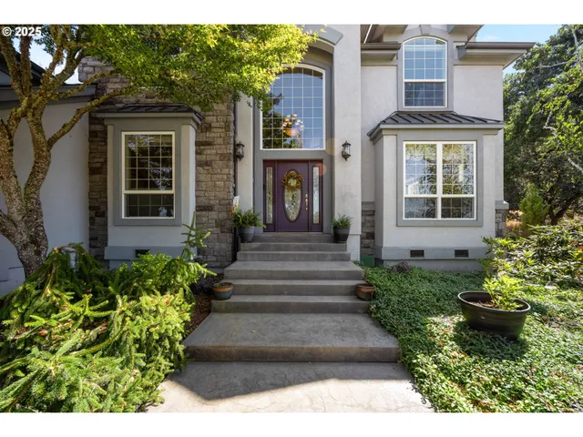 a front view of a house with a garden