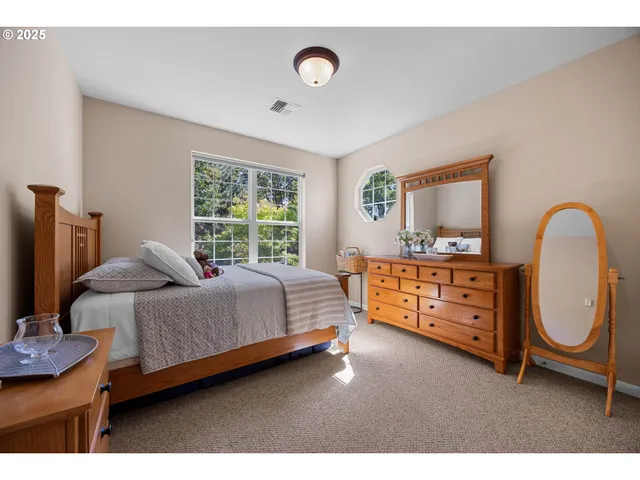 a bedroom with a bed and a dresser