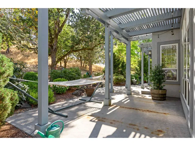 a view of a patio with a table chairs and a backyard