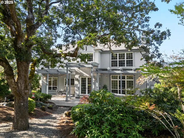 a front view of a house with yard patio and green space