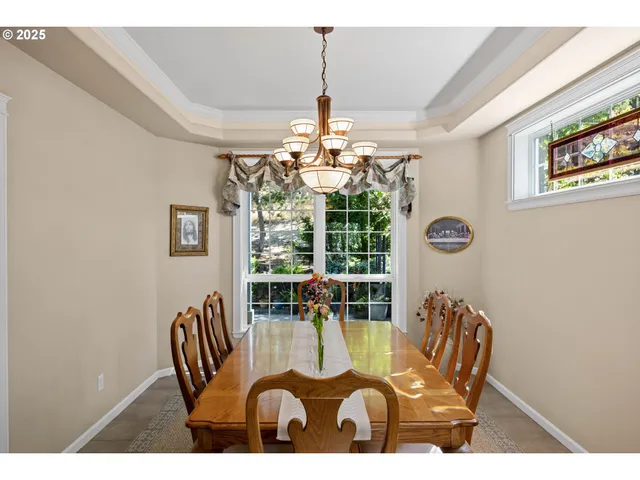 a view of a dining room with furniture wooden floor and chandelier