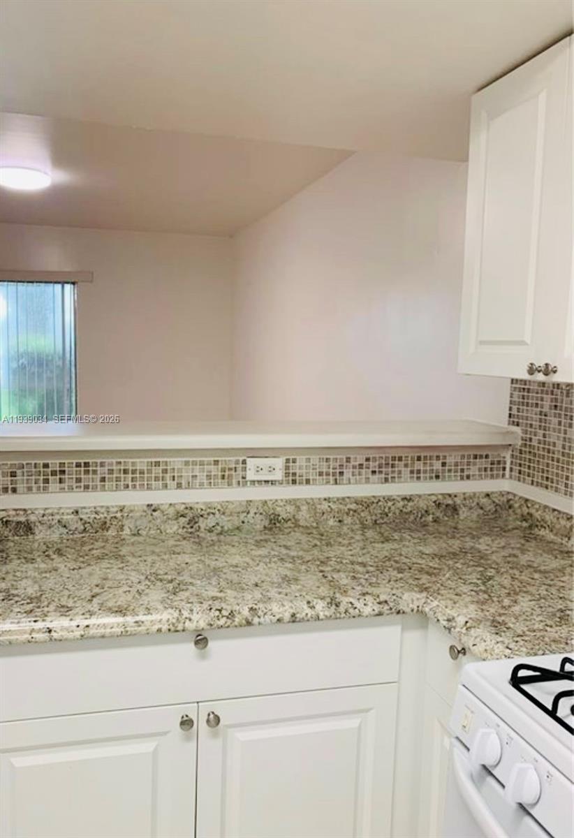 15340 Southwest 106th Terrace, Unit 819 Miami, FL 33196 - Photo 6 of 16 a view of kitchen with wooden floor