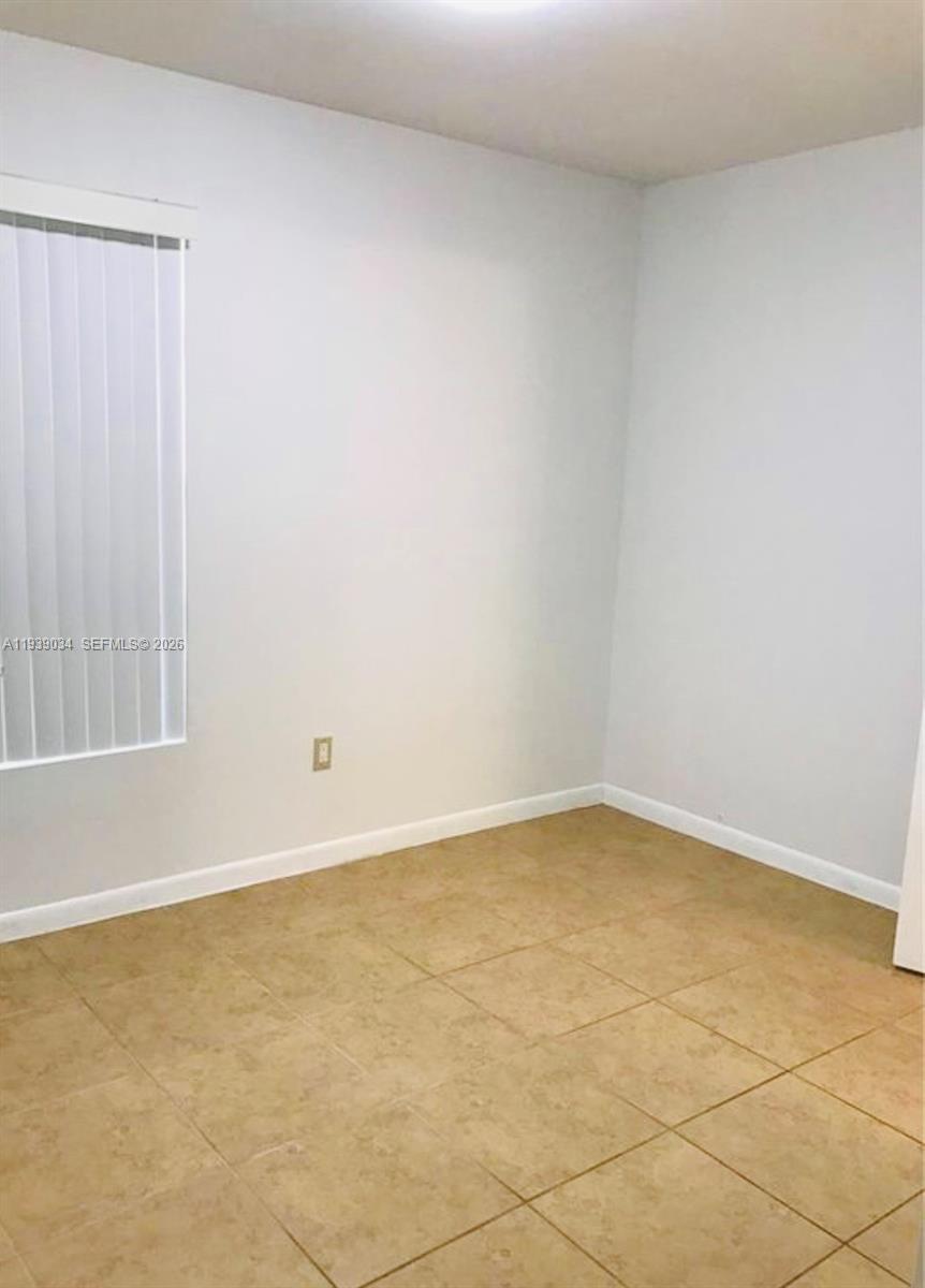 15340 Southwest 106th Terrace, Unit 819 Miami, FL 33196 - Photo 7 of 16 an empty room with a empty space and window