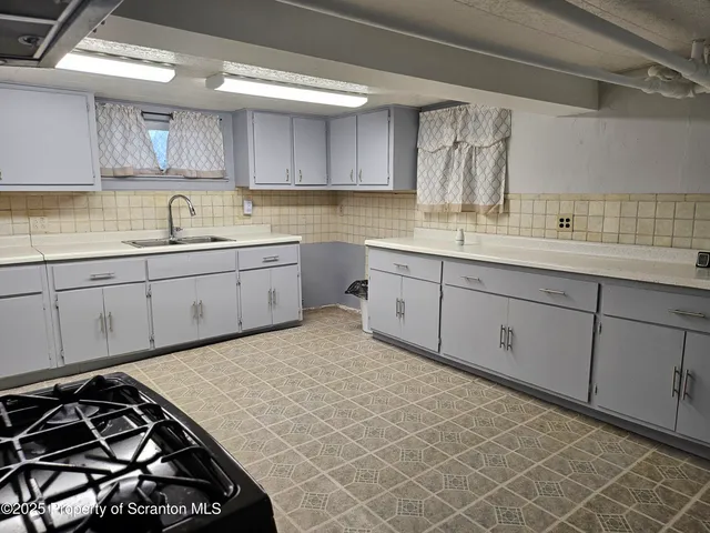 a kitchen with sink cabinets and stove
