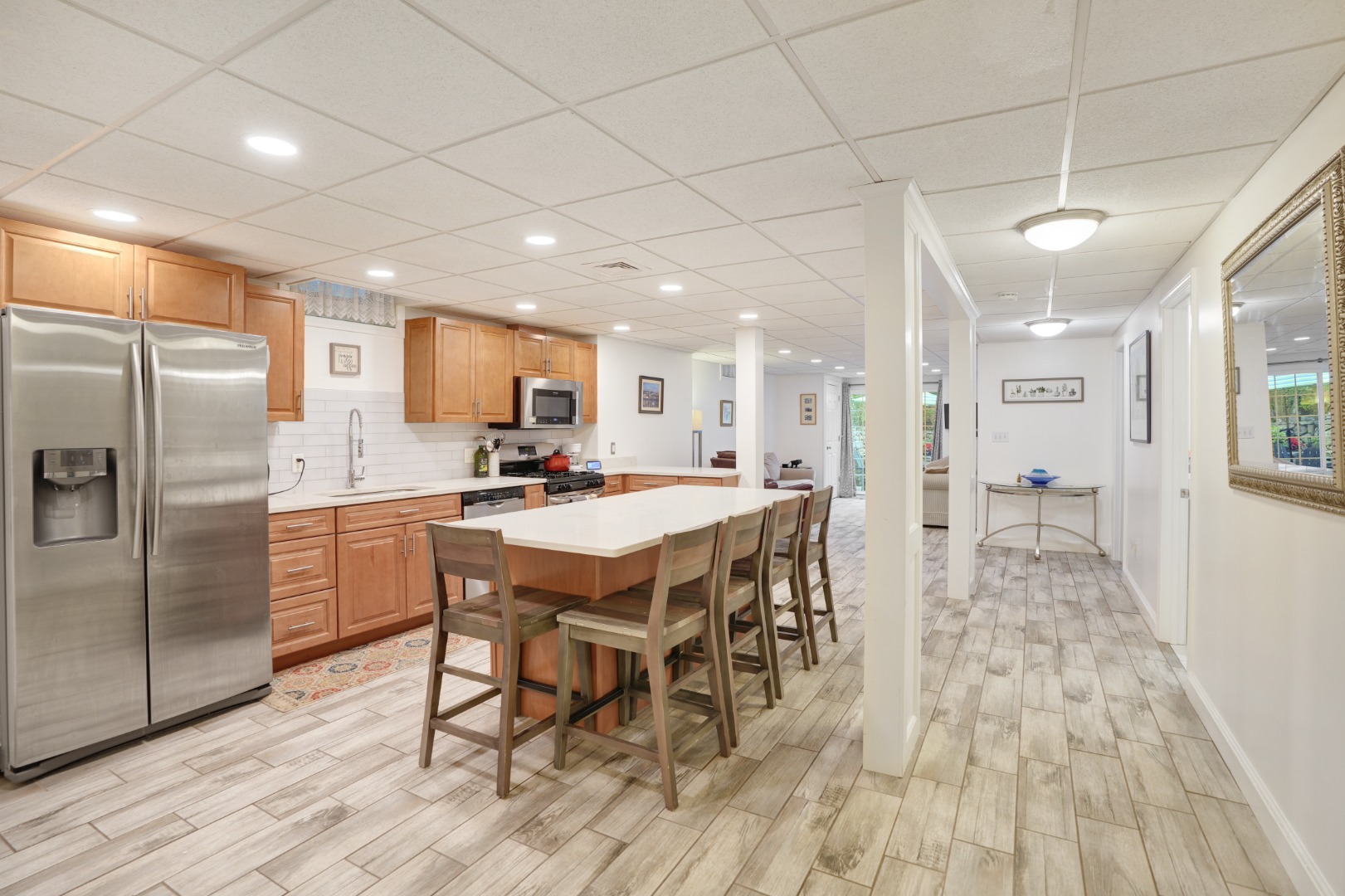 8 Fresh Pond Road Oak Bluffs, MA 02557 - Photo 24 of 40 a kitchen with stainless steel appliances a refrigerator a stove a sink dishwasher and a dining table with wooden floor