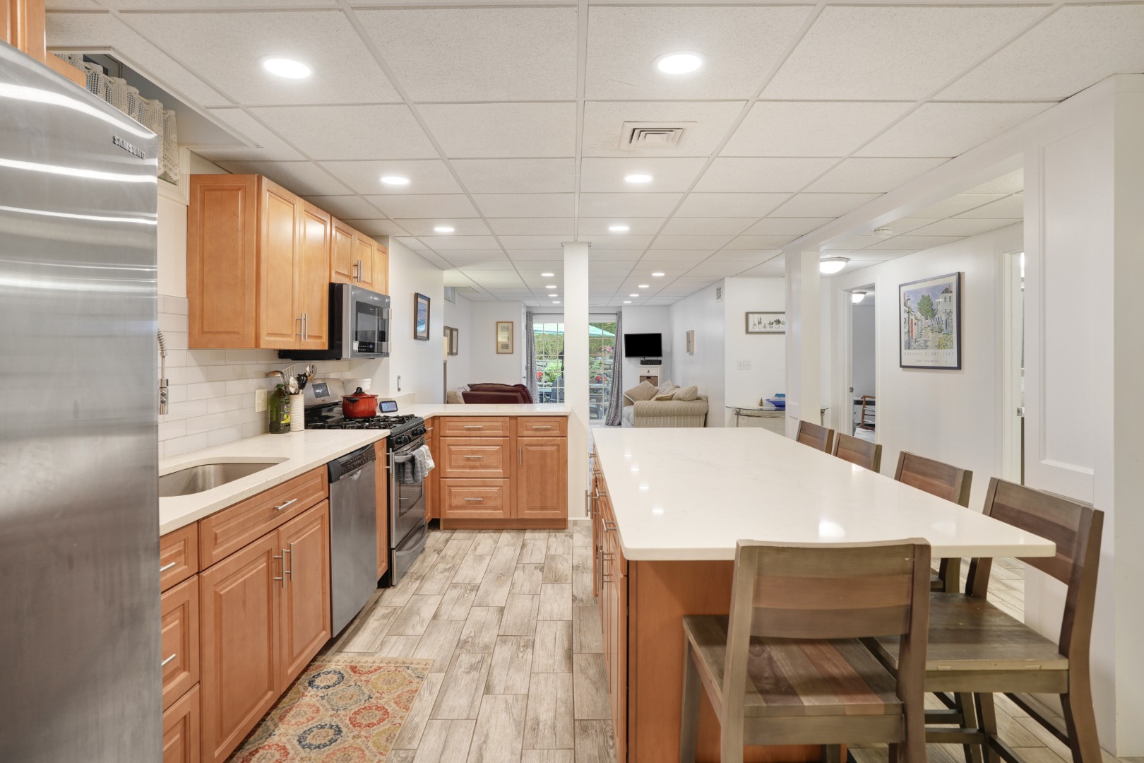 8 Fresh Pond Road Oak Bluffs, MA 02557 - Photo 25 of 40 a large kitchen with kitchen island a sink table and chairs