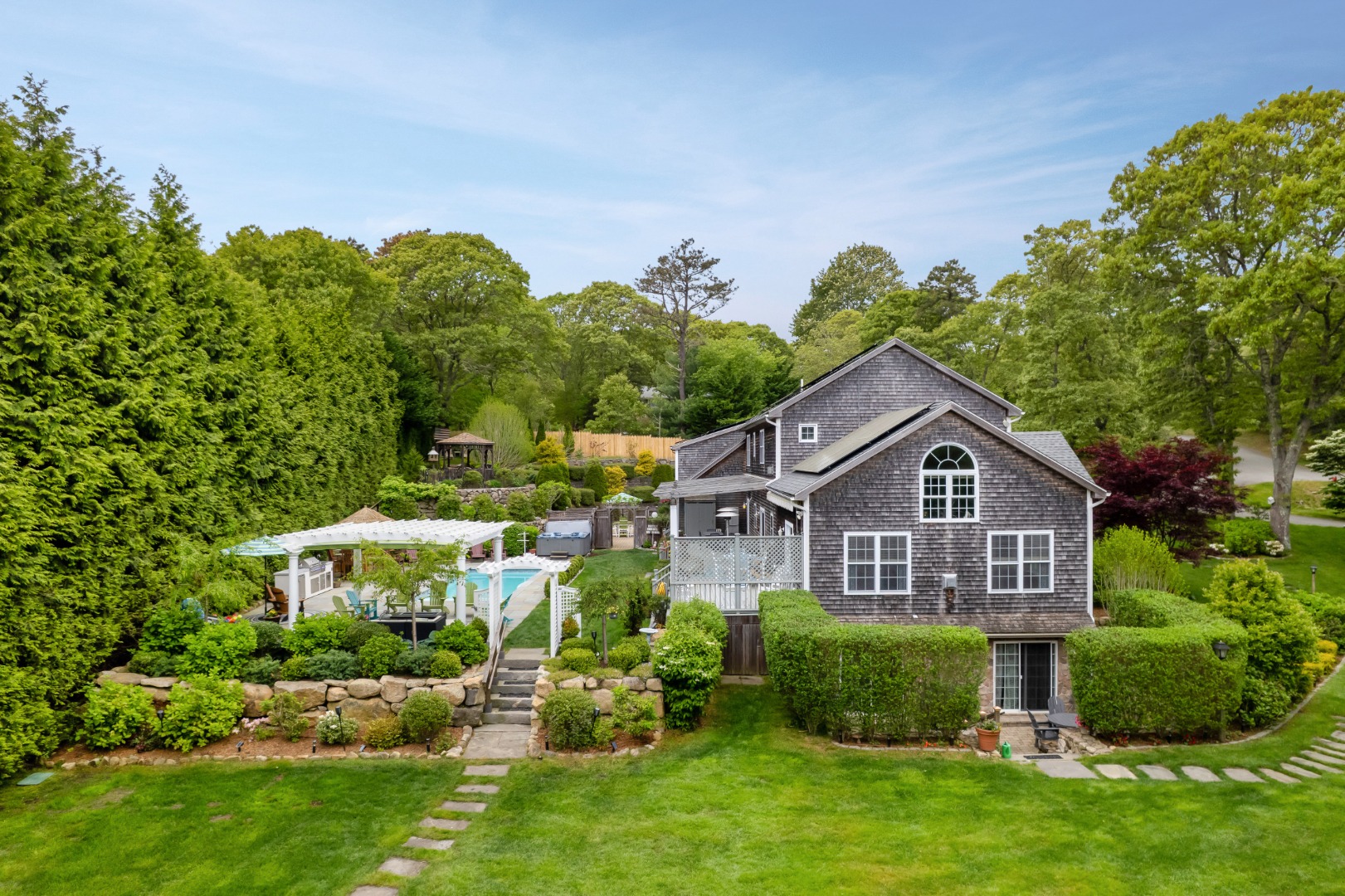 8 Fresh Pond Road Oak Bluffs, MA 02557 - Photo 28 of 40 a front view of a house with a yard
