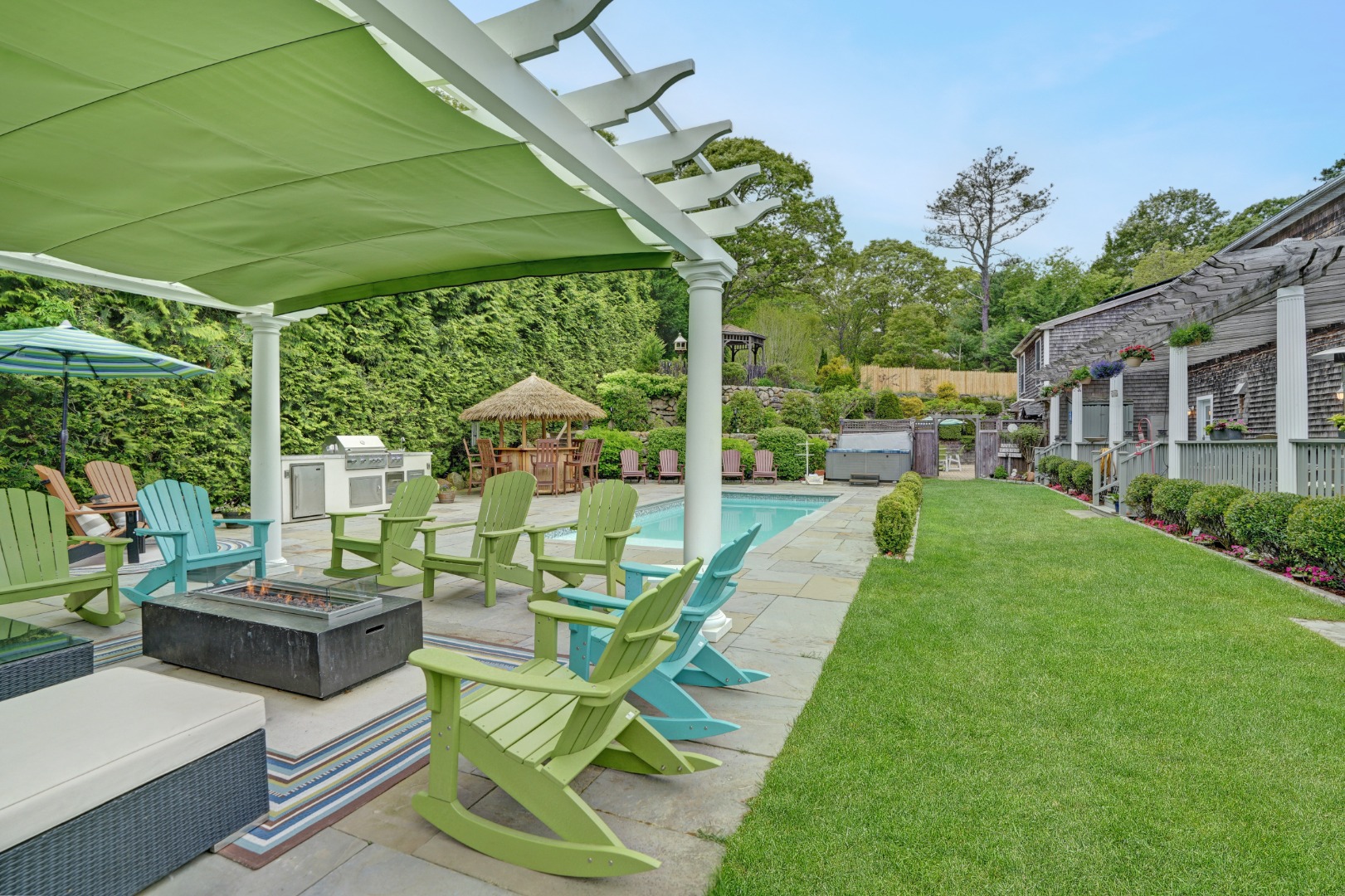 8 Fresh Pond Road Oak Bluffs, MA 02557 - Photo 30 of 40 a view of a patio with couches potted plants and a big yard