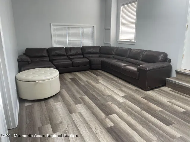 a living room with a couch and a window