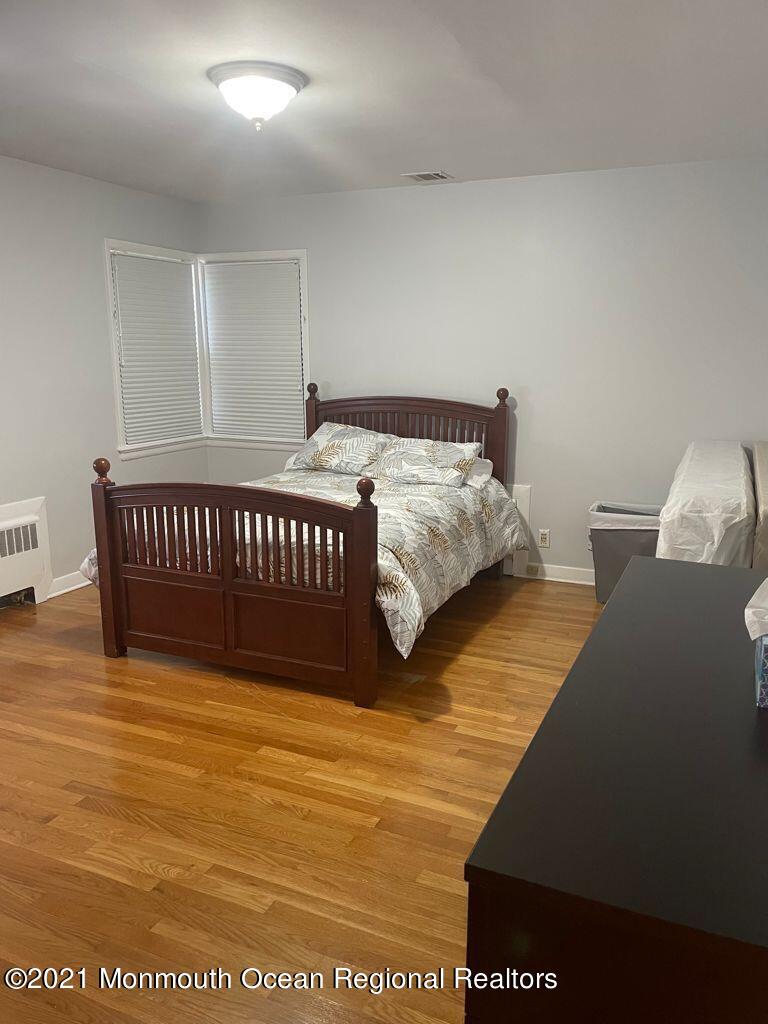 21 Berg Avenue Elberon, NJ 07740 - Photo 14 of 17 a bed sitting in a bedroom next to a window