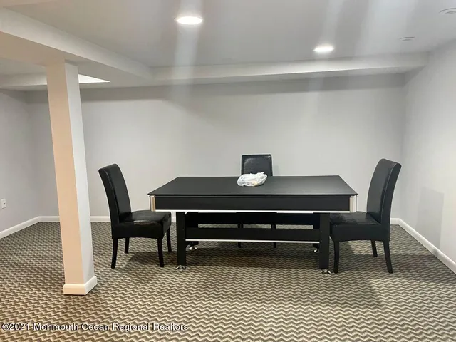 a view of a dining room with a table and chairs
