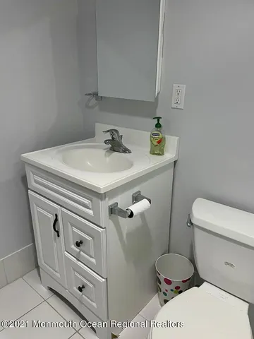 a bathroom with a sink a toilet and a mirror