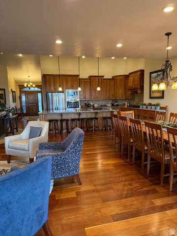 3145 South 500 West Vernal, UT 84078 - Photo 58 of 64 Dining space featuring a chandelier, dark wood finished floors, and vaulted ceiling