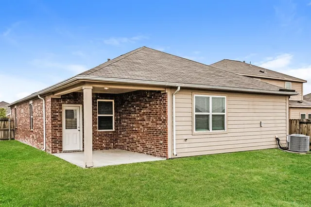 a view of a house with a backyard