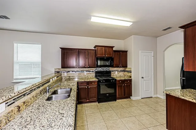 a kitchen with a stove a sink and a refrigerator