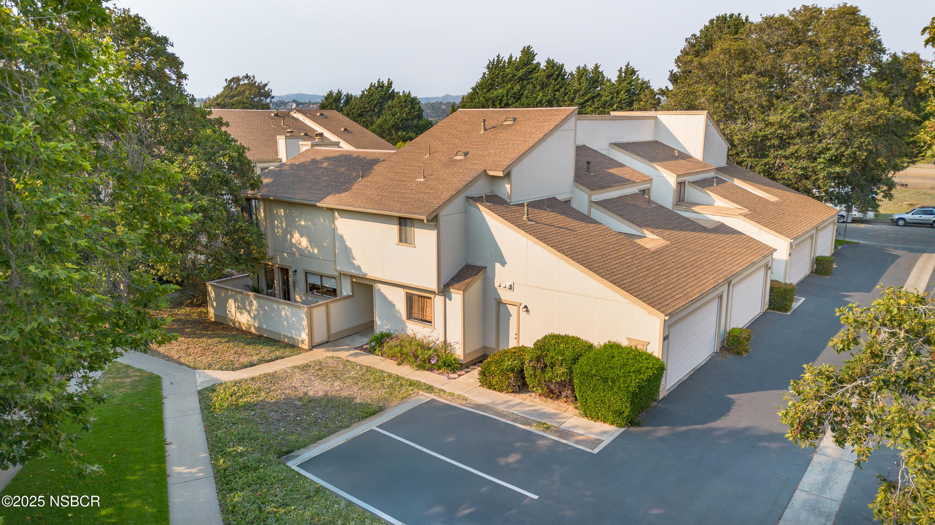 an aerial view of a house with a yard