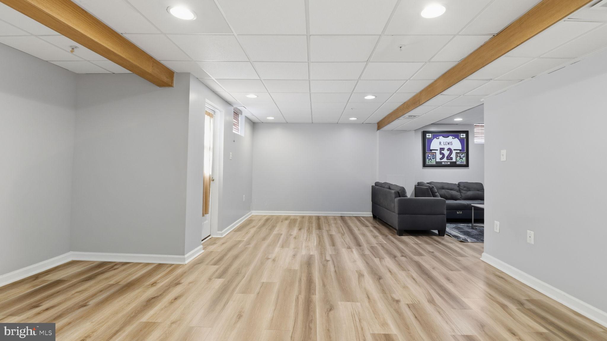 7105 Friendship Road Clinton, MD 20735 - Photo 30 of 42 Spacious, modern basement with warm tones.