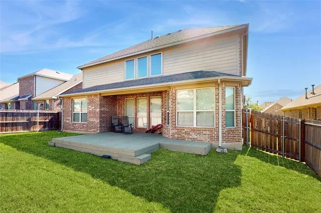 a view of a house with a yard and sitting area
