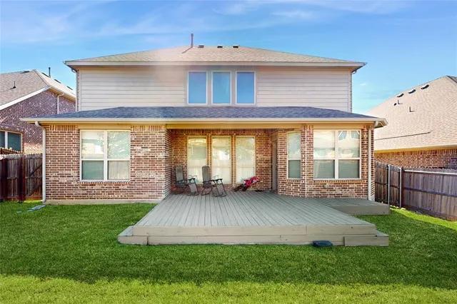 a view of a house with a yard and sitting area