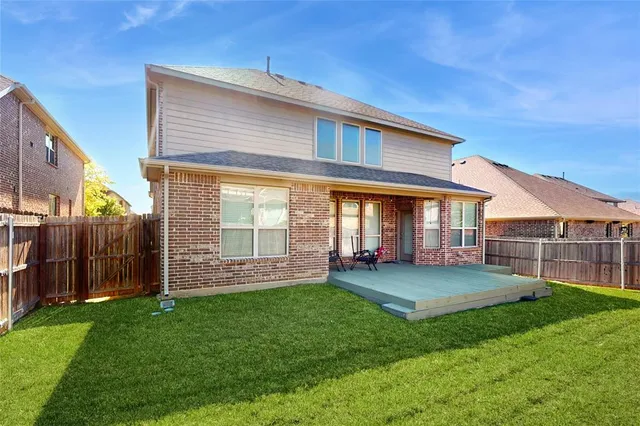 a view of a house with a yard and a garden