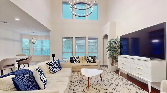 a living room with furniture and a potted plant