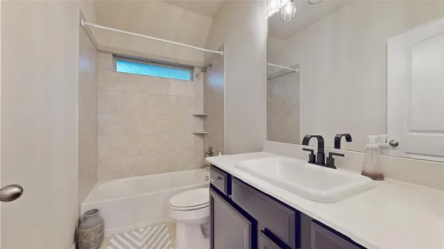 a bathroom with a sink toilet vanity and shower