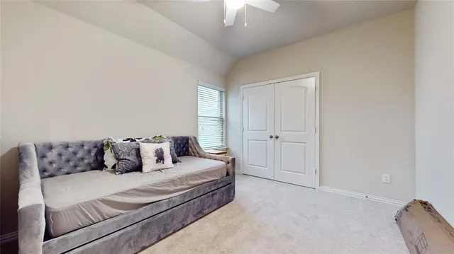 a bedroom with a bed and a couch