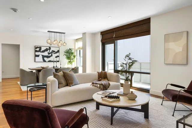 a living room with furniture and a potted plant